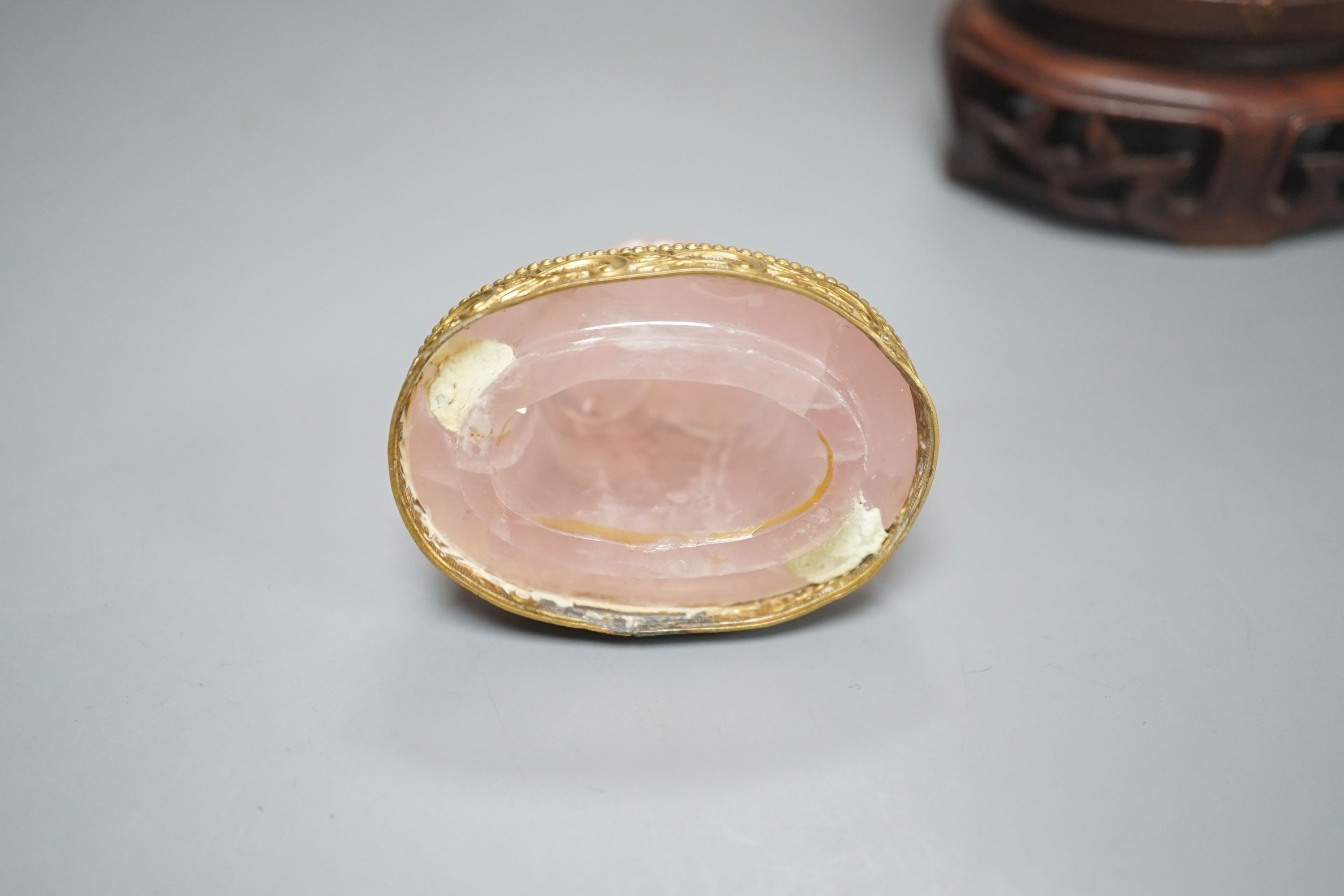 A late 19th/early 20th century Chinese carved rose quartz vase and cover, on a Hongmu stand, 23.5 cm high including stand.